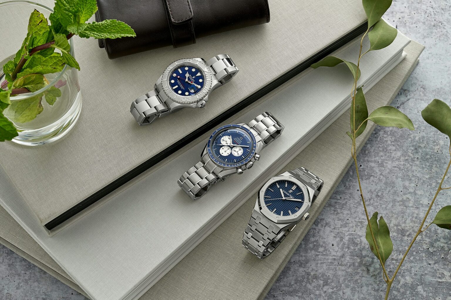 a group of watches on a stack of books