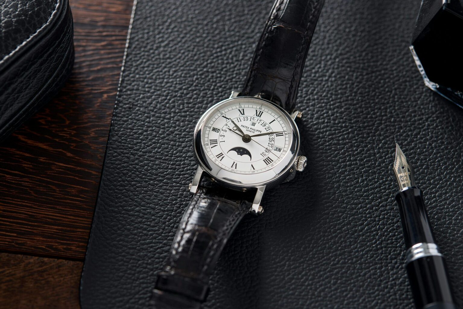 a watch on a black surface