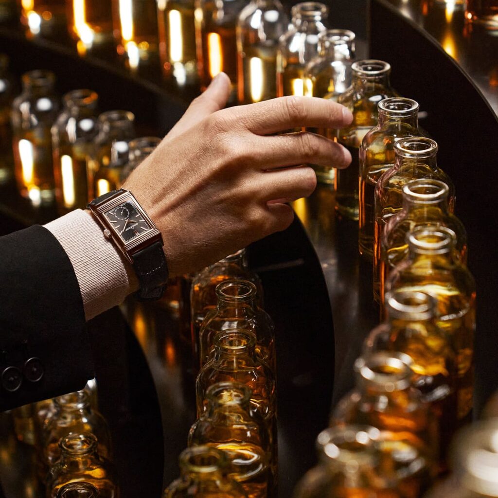 a hand touching a bottle